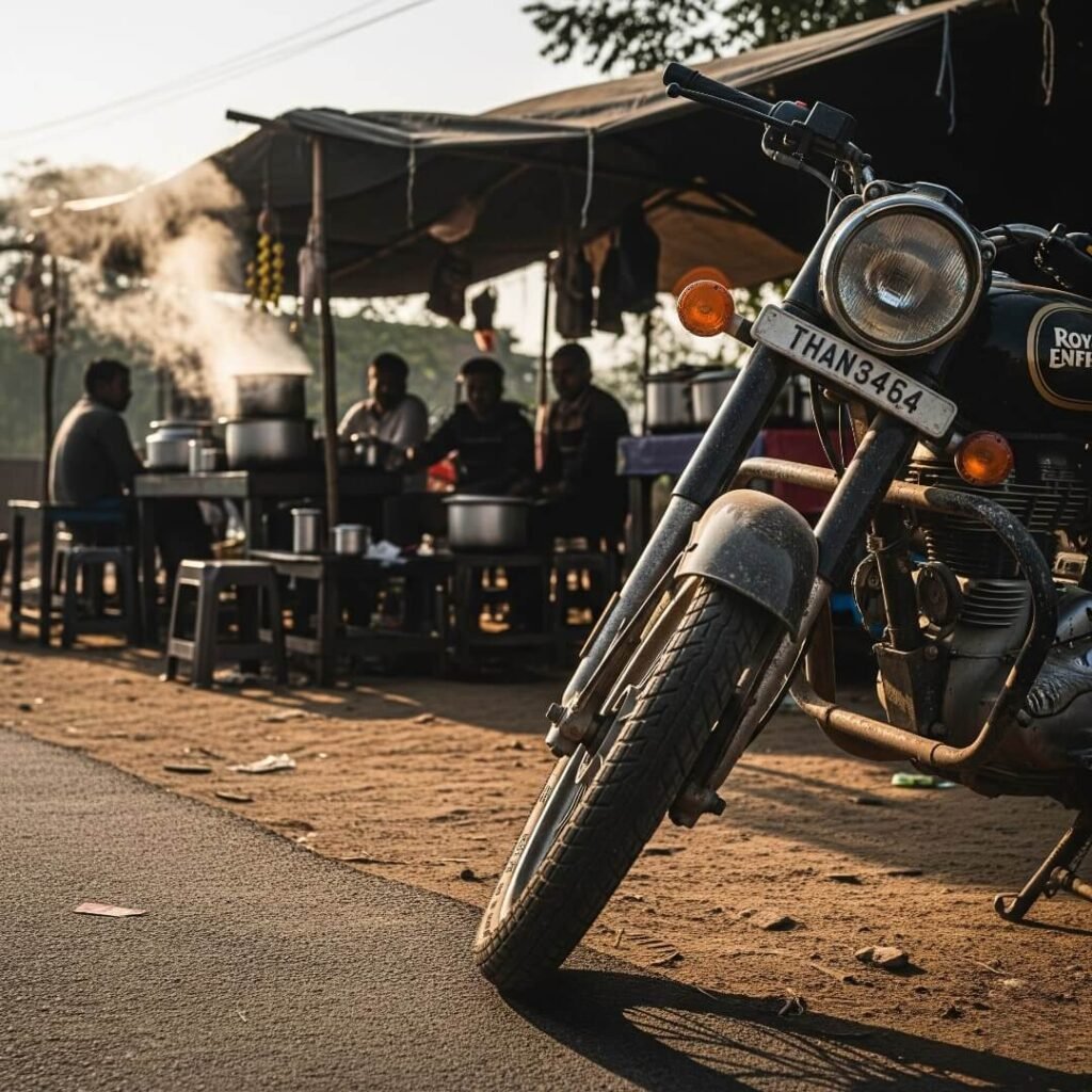 Motorcycle parked by chai stall on dusty Indian roadside.

